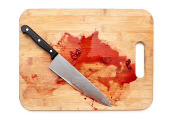 Cutting board with bloody surface and knife isolated on white. Top view