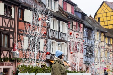 woman traveling in colmar, alsace at christmas