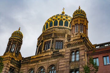 Great close-up view of the New Synagogue's main dome in Berlin, with its gilded ribs, flanked by...