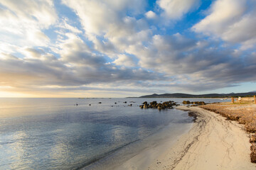 Isolated beach at sunrise with clouds, Sardinia, Italy