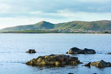 Sea, rocks and village of Budoni coastline, Sardinia, Italy