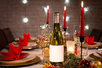 white wine bottle on a christmas holiday festive party table with wine a glass on red and gold shiny decoration