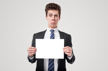 Curious businessman with blank placard