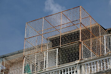 Building top floor rusty safety balcony grill