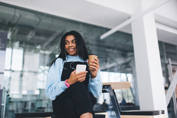 Fototapeta premium Black girl listen music in headphones on cellphone