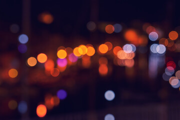 Night city lights in water reflection. Abstract warm background with blurred bokeh © Kira_Yan