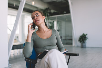 Businesswoman talking on mobile phone during work