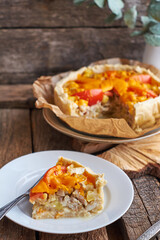 Pie with cheese, tomatoes and fish. Side view.