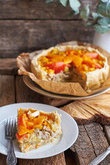 Pie with cheese, tomatoes and fish. Side view.