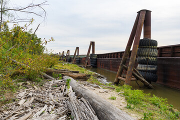 Docked Barges and Driftwood Deposited along the Mississippi River in New Orleans, Louisiana, USA