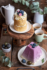 Traditional Easter Orthodox curd cake with blueberry and Easter cake with cream, blueberries.  Flowers, blueberry, eggs. Wooden background, side view	