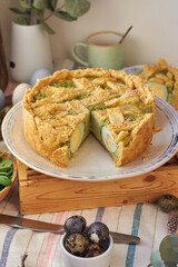 Easter pie with spinach, egg and cottage cheese. White background, side view