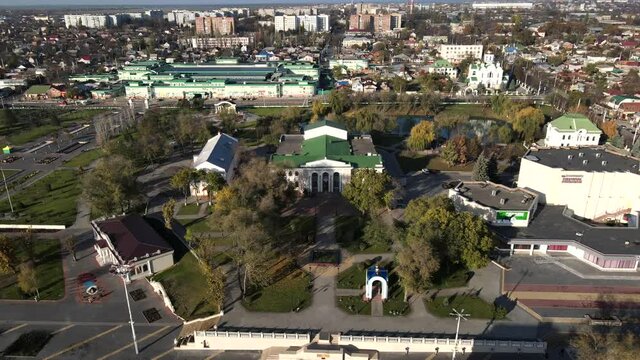 Aerial cinematic dynamic drone shot of the Palace of Culture in the center of the city of Tiraspol in Transnistria.