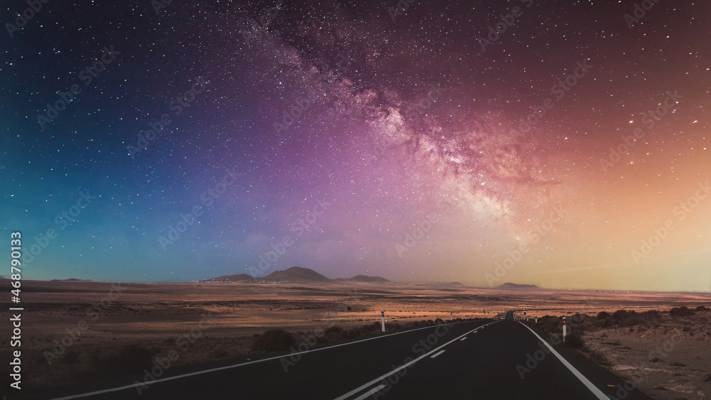 Wall mural beautiful view of the empty road with the milky way in the background.