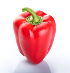 Beautiful young red bell pepper with a green branch on a white background with a shadow