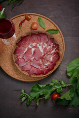 cold cuts products on a wooden board. Cured sausages, smoked brisket