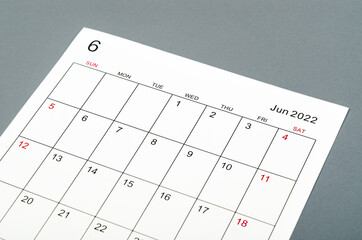 June 2022 calendar sheet on grey background.