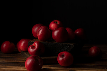 Fresh red apples on wooden table. On wooden background.