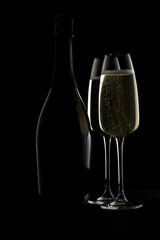 Two glass glasses with champagne and a bottle. Silhouette, contour.