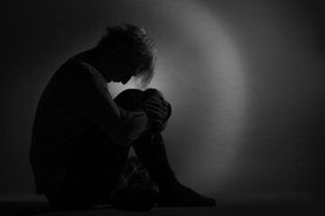 Silhouette of depressed and sad boy