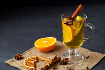 mulled wine with spices and orange.Christmas hot white mulled wine in glass with orange, honey,...