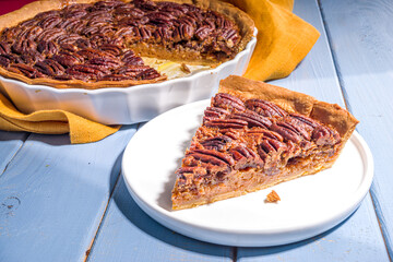 Thanksgiving dinner table with new traditional thanksgiving food - chicken, mashed sweet potatoes,...