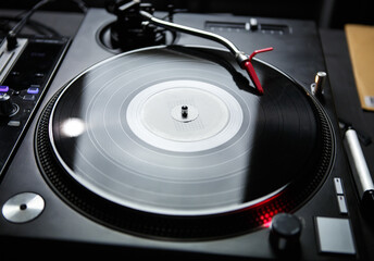 Dj turntable playing music. Vinyl record disc on turn table player device. Professional disc jockey...