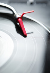 Professional dj turntable with vinyl record disc. Red turntables needle cartridge on analog record