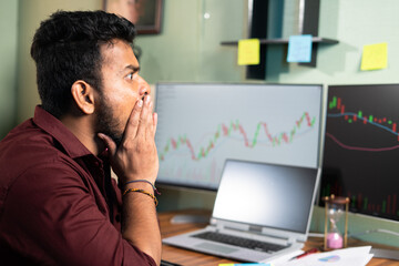 young intraday trader shocked due to sudden market crash while trading - concept of financial loss, risk in share or crypto markets