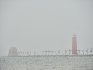 Foggy afternoon at the dual Grand Haven lighthouses in a panoramic image