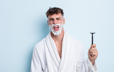young handsome man feeling disgusted and irritated and tongue out. shaving concept