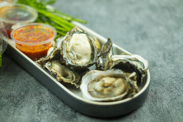 Oyster shell with spicy sauce in Thai food style