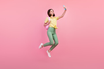 Full body profile side photo of young girl happy smile make selfie smartphone jump isolated over pink color background