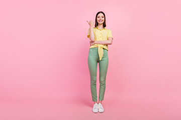 Fototapeta na wymiar Full size photo of young girl happy positive smile point thumb empty space ad promo choice isolated over pink color background