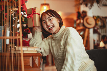 Happiness girl hold christmas gift box at home celebration concept