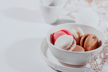 macaroon cakes in a white porcelain bowl on a white background