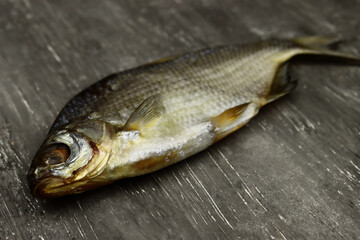 dried fish on a gray background close-up, beer snack