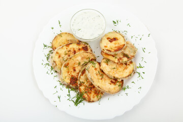 Fried zucchini with sauce in white plate. Top view