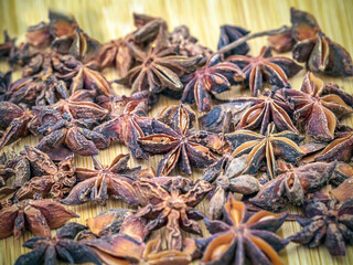 Dried anise stars on a wooden background. Close-up