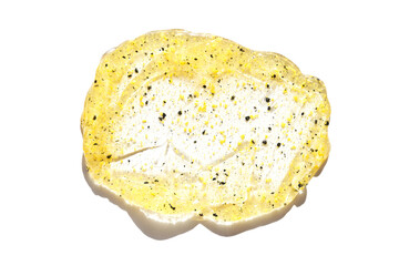 Face scrub texture. Cream skincare cosmetic. Organic stroke. Feet oily cleanser smudge. Particles in gel. White background. Top view. Yellow and black fluid treatment