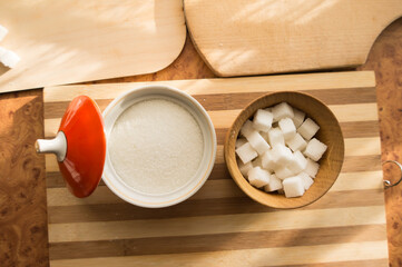 Sugar and refined sugar are poured into the sugar bowl on the table.