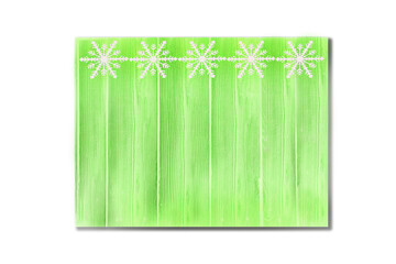 Winter wooden green grass herbal mint nature background with snowflakes top. Texture of painted wood vertical boards on a white background. Christmas, New Year card with copy space.