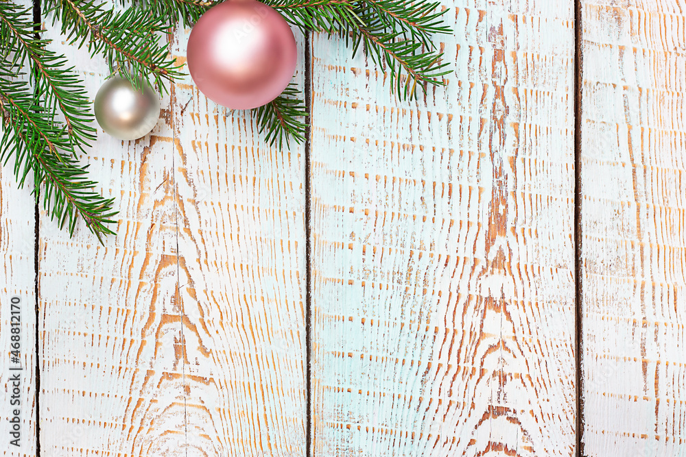 Wall mural spruce branch with christmas decorations on blue wooden background