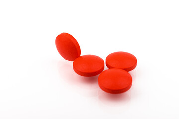 Red pills on a white background, isolated. Pharmacy. Treatment.