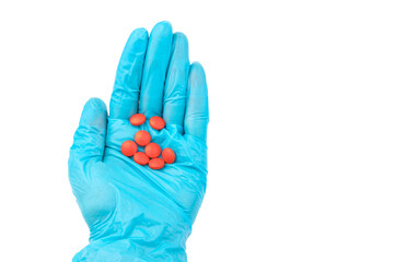 Hand doctor in medical blue gloves hold red pill.  Pill Research Concept.