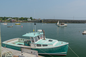 Fototapeta premium The Bailey to Orr Island cribstone style bridge is the only one of it's kind in the world connecting Bailey and Orr Island in Maine over Will's Gut inlet. It was built to accommodate the strong tides