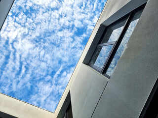 look to the top to see sky from internal court of modern housing. sky view reflection on modern...