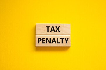 Time to tax penalty symbol. Concept words Tax penalty on wooden blocks on a beautiful yellow background. Business and tax penalty concept. Copy space.