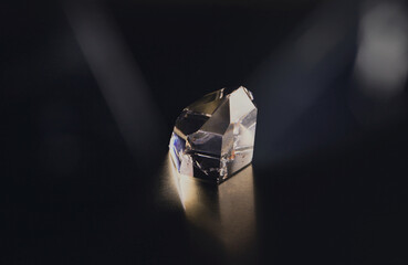 Crystals refracting light. Stone quartz prism isolated on black background. Relaxation, meditation,...