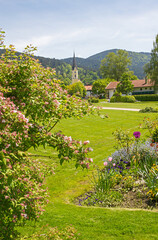 Obraz premium idyllic spa garden Schliersee with view to St. Sixtus church